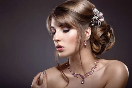 Beautiful brunette girl with evening make-up and perfect skin. Beauty face. Picture taken in the...