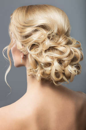 Portrait of a beautiful  woman in image of the bride. Picture taken in the studio on a black background. Beauty hair. Hairstyle back viewの写真素材