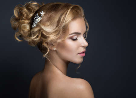 Portrait of a beautiful blond woman in the image of the bride. Picture taken in the studio on a black background. Beauty face and Hairstyleの写真素材