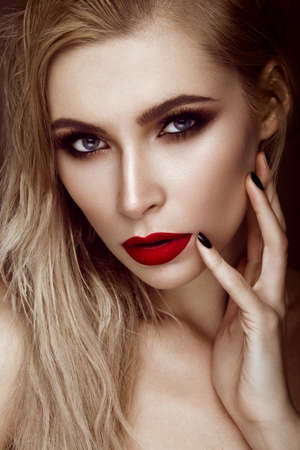 Beautiful sexy blonde girl with sensual lips, fashion hair, black art nails. Beauty face. Photo shot...