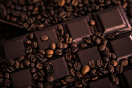 Roasted coffee beans and chocolate bar  close-up.の写真素材