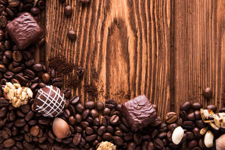 Roasted coffee beans, chocolate, candy, nuts  and the place for  inscriptions on the wooden...