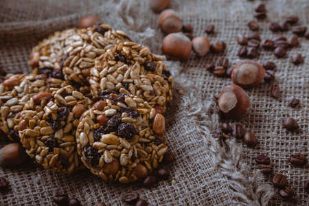 Roasted coffee beans, muesli with nuts on the wooden background.