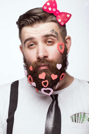 Funny bearded man with hearts Valentines Day. Portrait shot in studio