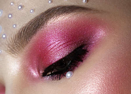 Beautiful girl with perfect art makeup and pearl beads. beauty face. Photos shot in the studio.
