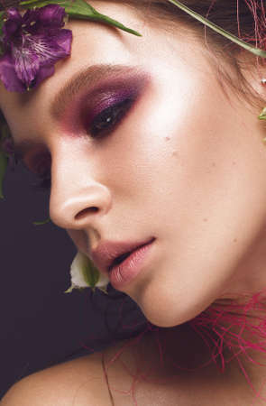 Beautiful girl with art make-up and flowers. beauty face. Photos shot in studio