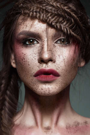 Beautiful strange girl with creative art make-up. Beauty face. Photo taken in studioの写真素材