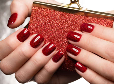 Bright festive red manicure on female hands. Nails design.の写真素材