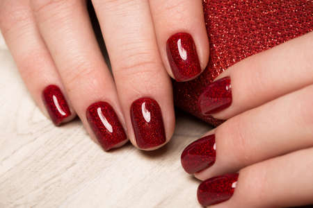 Bright festive red manicure on female hands. Nails design.の写真素材