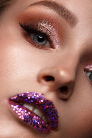 Beautiful girl with creative glitter make-up. Beauty face. Photos shot in studioの写真素材