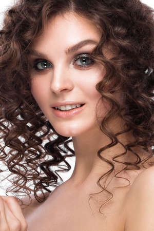 Beautiful brunette girl with a perfectly curly hair, and classic make-up. Beauty face. Picture taken...