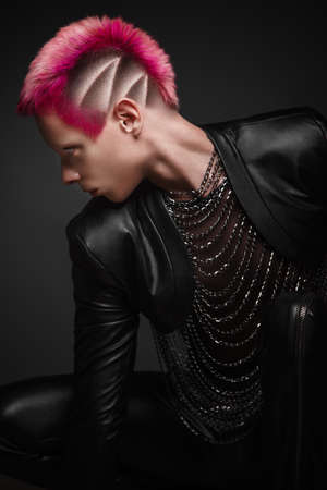 young man with pink hair and creative makeup in art clothes. Photo taken in the studioの写真素材