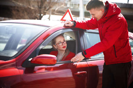 The driver is an auto school instructor and a female student on an examination car. Lesson at the...