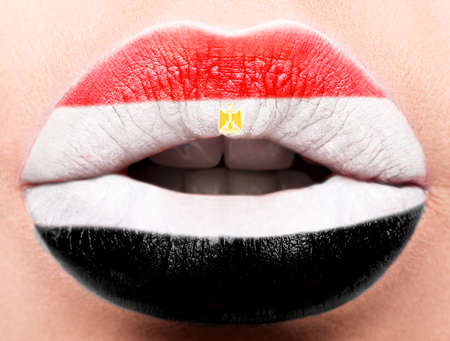 Female lips close up with a picture of the flag of Egypt. white, red, blackの写真素材
