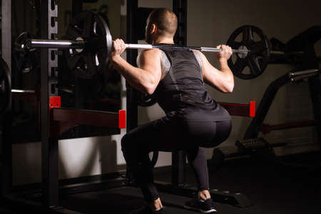 Sporty sexy men with great abdominal muscles in black sportswear working out in the gymの写真素材