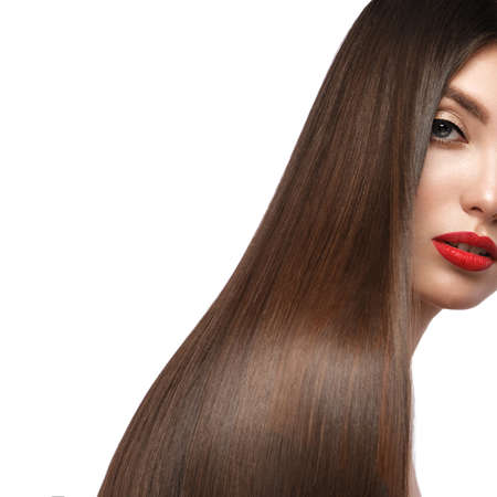 Beautiful brown-haired girl with a perfectly smooth hair, and classic make-up. Beauty face and hair. Picture taken in the studio.の写真素材