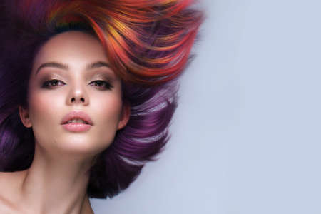 Beautiful woman with multi-colored hair and creative make up and hairstyle. Beauty face.の写真素材