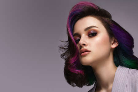 Beautiful woman with multi-colored hair and classic make up and hairstyle. Beauty face.の写真素材