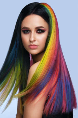 Beautiful woman with multi-colored hair and creative make up and hairstyle. Beauty face.の写真素材