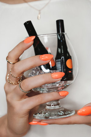 Bright neon manicure on female hands with accessories. Nail design.の写真素材