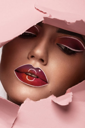 Beautiful woman with creative makeup and purple lips. Beauty face. Art makeup.