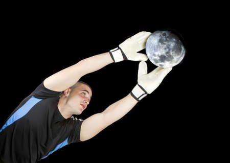 soccer goalkeeper whit the moon ball in his handsの写真素材