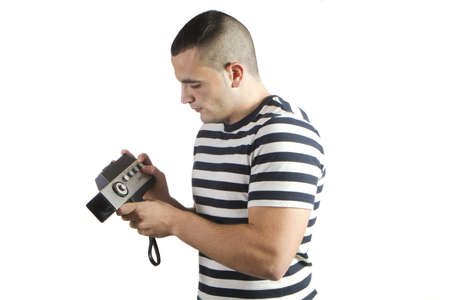 young man with old movie camera domesticの写真素材