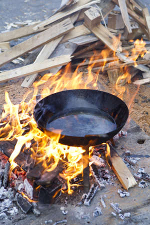pan with sunflower oil on the fire in a wood fireの写真素材