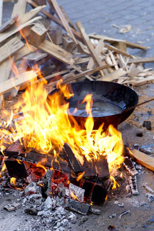 pan with sunflower oil on the fire in a wood fireの写真素材