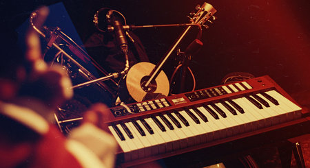 Pianist playing the keyboard on a dark background. Selective focus.の素材