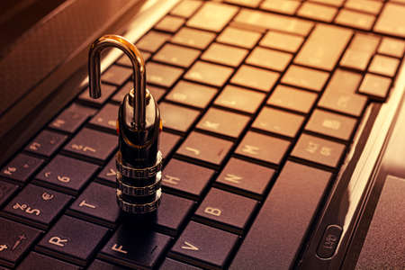 keyboard unlock - security concept padlock with key on keyboard