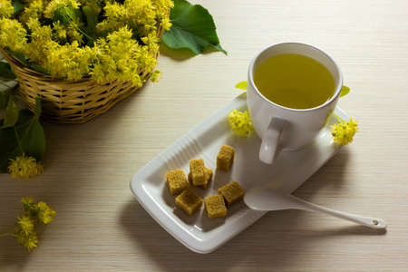 Linden tea cup and woven basket with linden flowers  Tea time