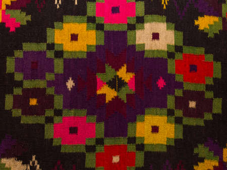 Close up Old traditional romanian wool carpet with ancient motifsの写真素材