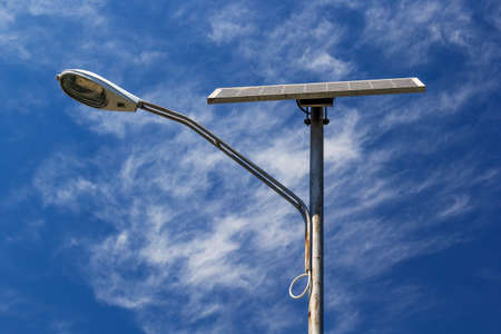 Solar powered street light with blue sky and cloudsの写真素材