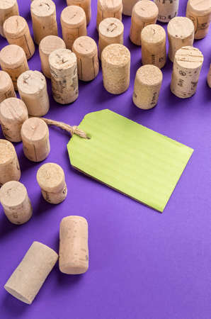 Wine cork stoppers with green label on purple background.Useful as alcohol background.の写真素材