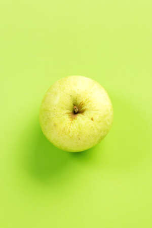 Green apple on green background.Useful as a food backgroundの写真素材