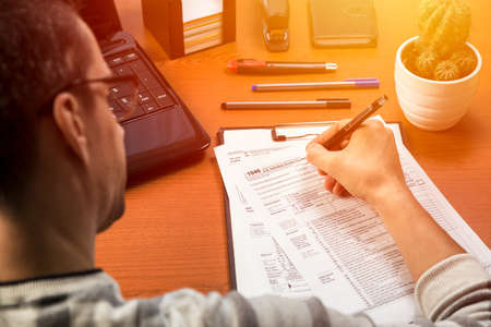 Person completing 1040 tax formの写真素材