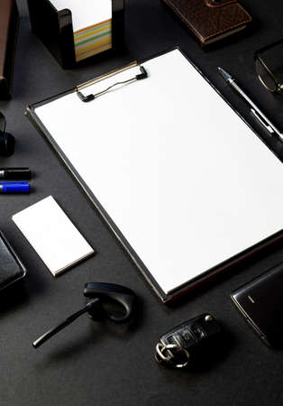 Office desk with mock-up of paperwork , business card  on black backgroundの写真素材