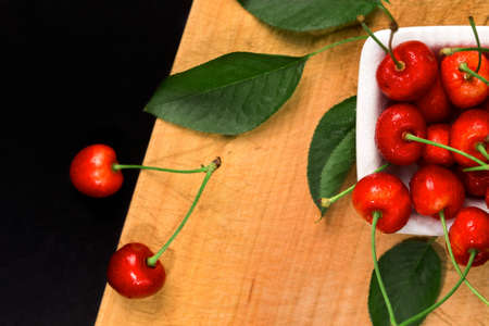 Fresh ripe cherry on wood background. Useful as food backgroud presentation.の写真素材