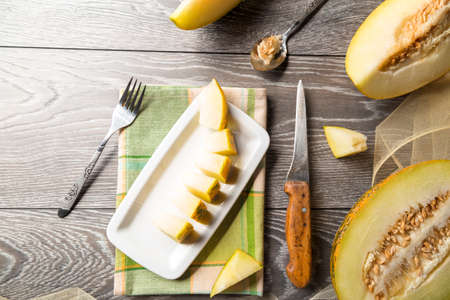 Sliced cantaloupe melons over the wood table