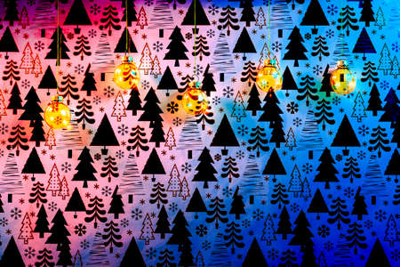 Golden Christmas baubles on colored Christmas background.