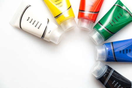 Tubes of colorful acrylic paints over white with copy spaceの写真素材
