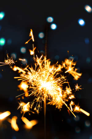 Burning sparkler with bokeh light backgroundの写真素材
