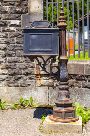 Old mailbox near the gate of a houseの写真素材