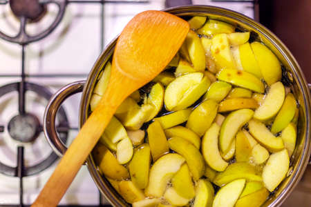 Sliced green apples in a pan to make apple compoteの写真素材