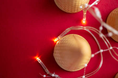 Ice cream cones with fir tree installation over red background with place for textの写真素材