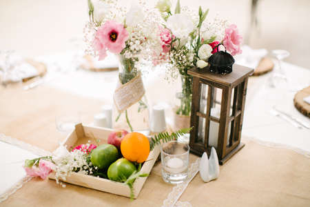 Wedding dining table and colorful flowers. Wedding day and wedding dining table. Fruit basket, apple, orange, lime.の写真素材