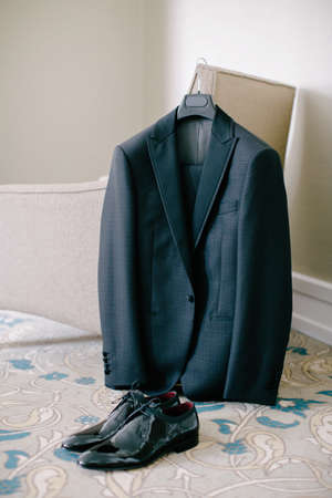 Groom suit and black groom shoes. Indoor and medium angle. Wedding preparations.の写真素材
