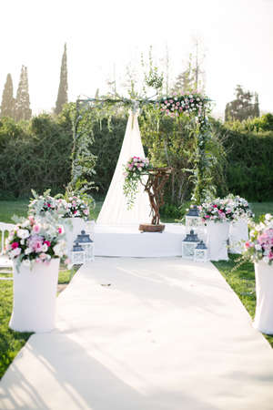 Wedding arch. Rustic wedding. Wedding area covered with flowers.の写真素材