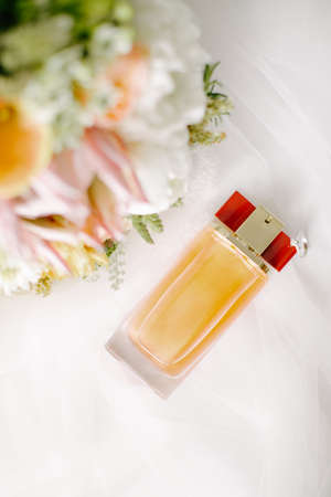Bridal flower and perfume bottle. On a white background.の写真素材